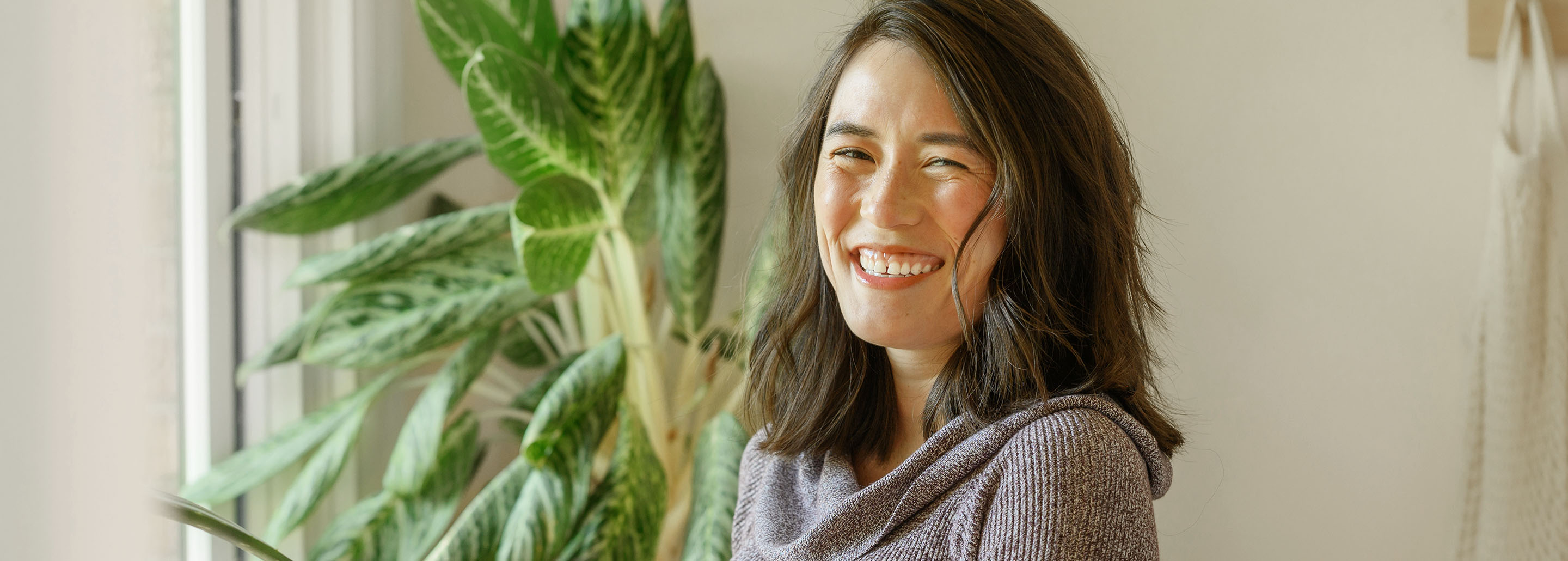 Woman smiles ahead showing off her beautiful, white smile.